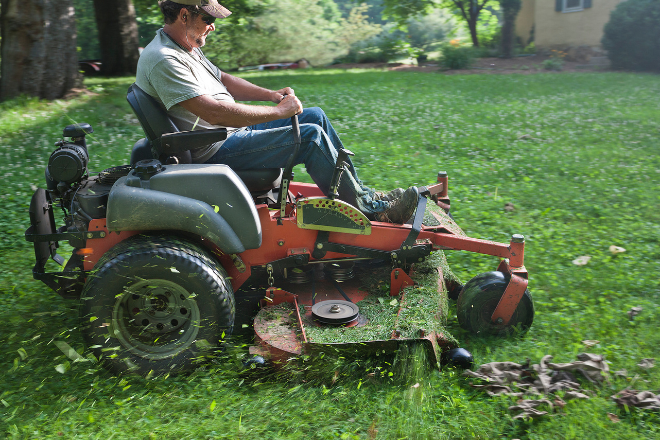 Landscaper on riding lawn mower